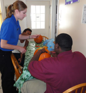 2 men carving pumpkins