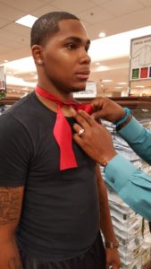 Helping a young man tie a bowtie